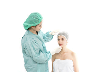 Beautiful young woman is sitting with doctor, examining her face before surgery. Make up beauty concept.