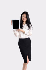 A woman holds a tablet