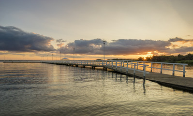 Fototapeta premium Sunset on the lake, wooden, white pier