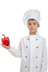 Cute boy with red pepper in Chef uniform on white background