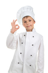 Cheerful handsome boy wearing chef uniform