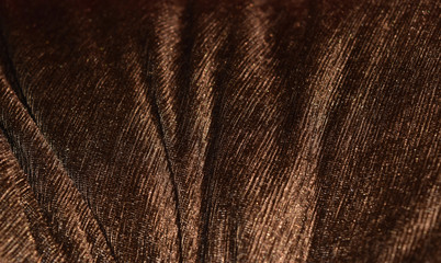 Curved wave soft surface of brownish gold velvet.