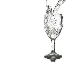pouring water on a glass isolated on white background. Clipping path