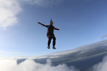 Skydiver girl is falling in the sky.