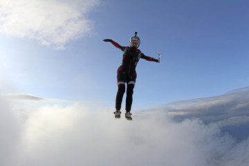 Skydiver girl is falling in the sky.