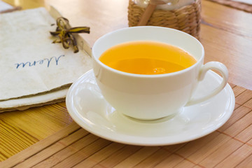 Herbal tea in the white cup on a saucer