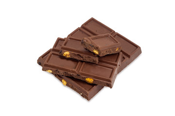 Pieces of the milk chocolate on a white background