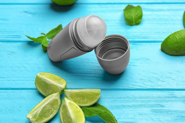 Composition with deodorant for men and lime on wooden background