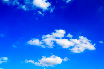 Bright blue sky with white clouds