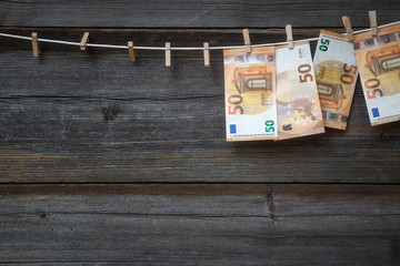 Euro banknotes hanging on clothesline