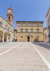 Fototapeta na wymiar The facade of the Palazzo Borgia or Vescovile on the beautiful Piazza Pio II in the historic center of Pienza, Siena, Italy, on a sunny day