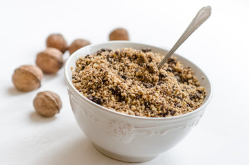 Crushed walnut with chocolate in bowl 