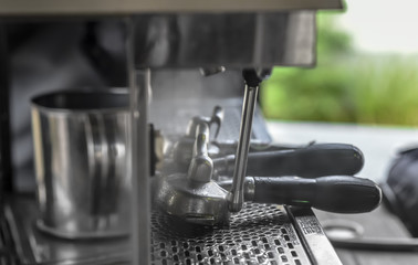 Coffee scoop cleanning with steam at Espresso machine