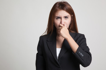 Young Asian woman  holding her nose because of a bad smell.