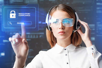 Business, Technology, Internet and network concept. Technology future. Young businesswoman working in virtual glasses, select the icon REGULATORY COMPLIANCE on the virtual display