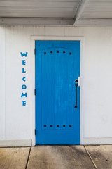 White wall with blue door