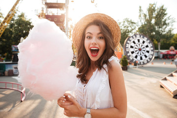 Close up portrait of a smiling girl holding cotton candy