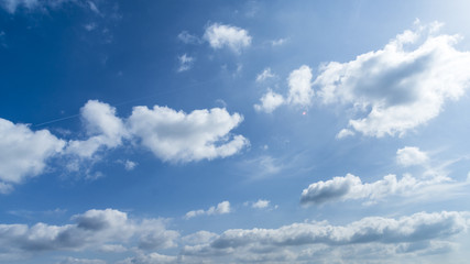 Blue sky with clouds and sun