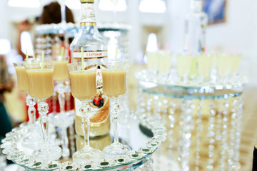 Glasses with tall legs stand on mirror tray