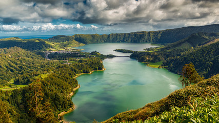 Establishing shot of the Lagoa das Sete Cidades lake taken from Vista do Rei in the island of Sao Miguel, The Azores, Portugal. The Azores are a hidden gem holiday destination in Europe.