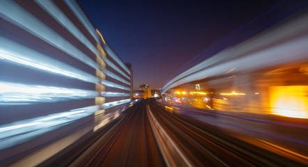 A railway track and skyscrapers seen through a long exposure motion blur in London, England, UK during early evening