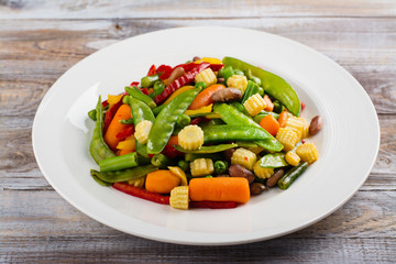 Stir fry vegetables on white plate. Copy space