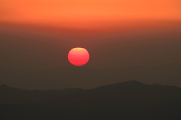 sun behind the mountains at sunset