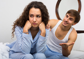 Smiling husband trying to reconcile with wife