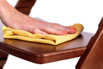 cleaning dust from the furniture by hand with a soft cloth