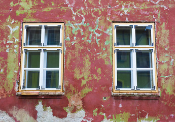 windows and old cracked wall of abandoned house