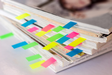 many colorful bookmarks in a magazine with the shallow depth of scene