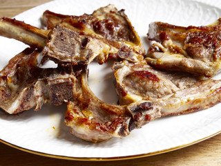 Cooked lamb chops  in a white dish