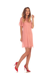 full body picture of a smiling young woman in dress