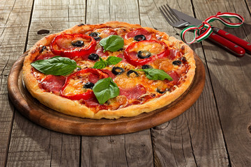 Delicious pizza served on wooden plate 