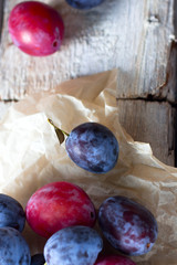Fresh plum fruit on rustic white wood