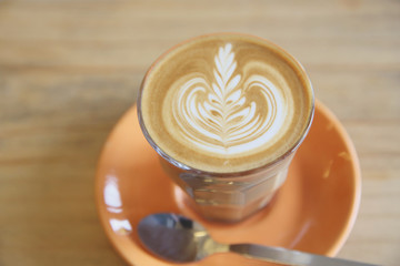 Cappuccino coffee on wood background in coffee shop