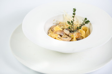Tagliatelle pasta with mushrooms on white background