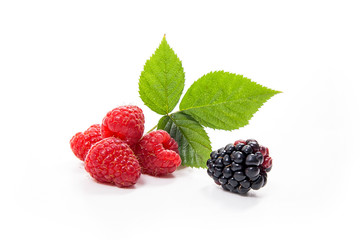 Ripe raspberries with leaf and blackberry isolated on white background.