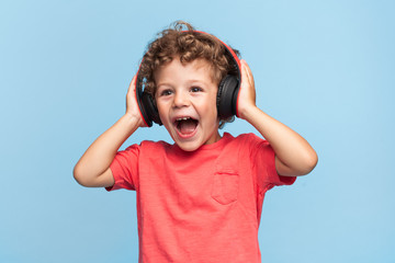 Excited kid posing in headphones