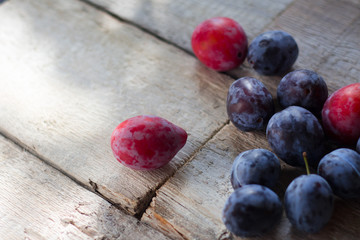 Plums on a rustic wooden table