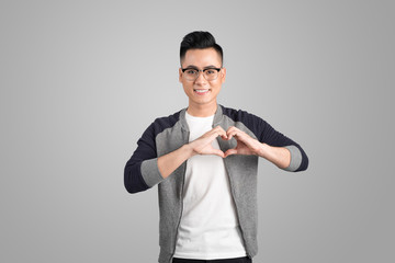 Portrait of cool handsome asian man with hands making heart shape