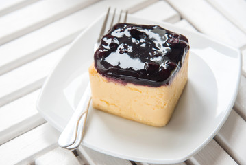 Blueberry Cheesecake close up pie on white wooden table, sweet dessert.