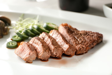 Sliced steak served with vegetables