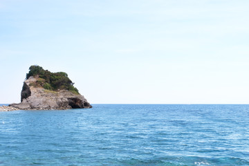 Fototapeta na wymiar View of blue sea with rocky island