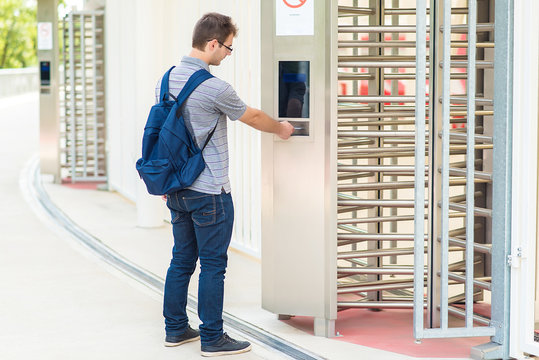 Young man puts the card into the reader system