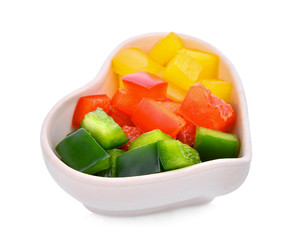 chpopped sweet bell pepper or capsicum in the white heart cup isolated on white background