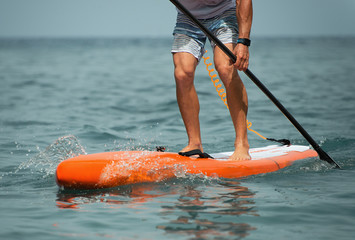 Stand up paddle board man paddleboarding on ocean - obrazy, fototapety, plakaty