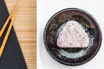 Onigiri , Japanese food rice ball made from white rice formed into triangular or cylindrical shapes. And often wrapped in nori (seaweed).