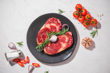 Raw fresh beef on white stone background, top view