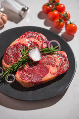 Raw fresh beef on white stone background, top view